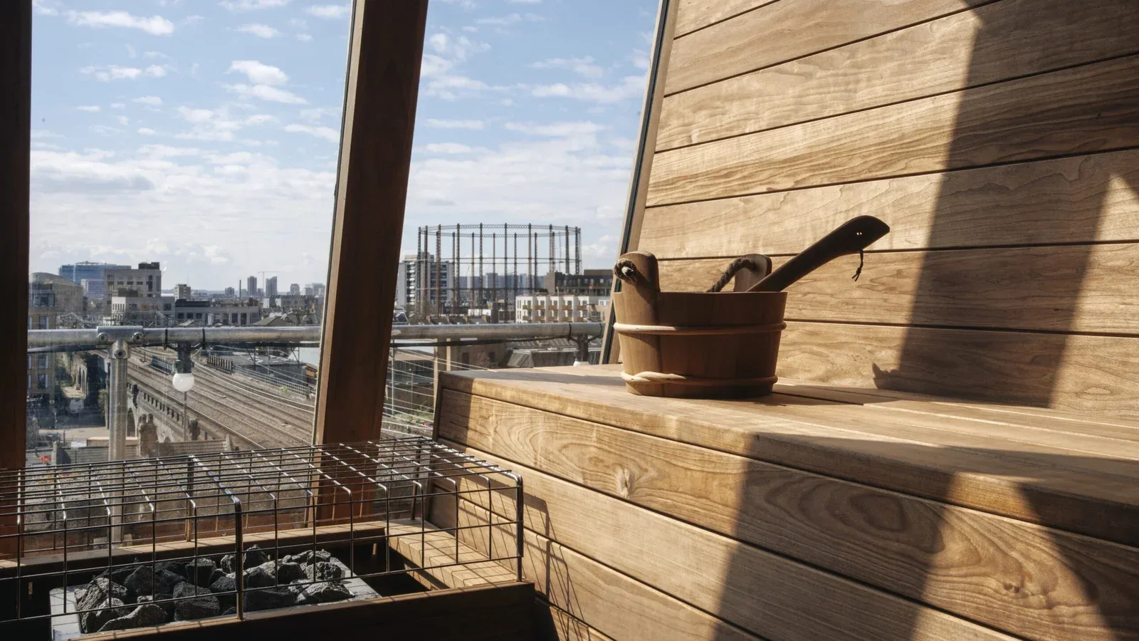 Wooden rooftop sauna with a city view