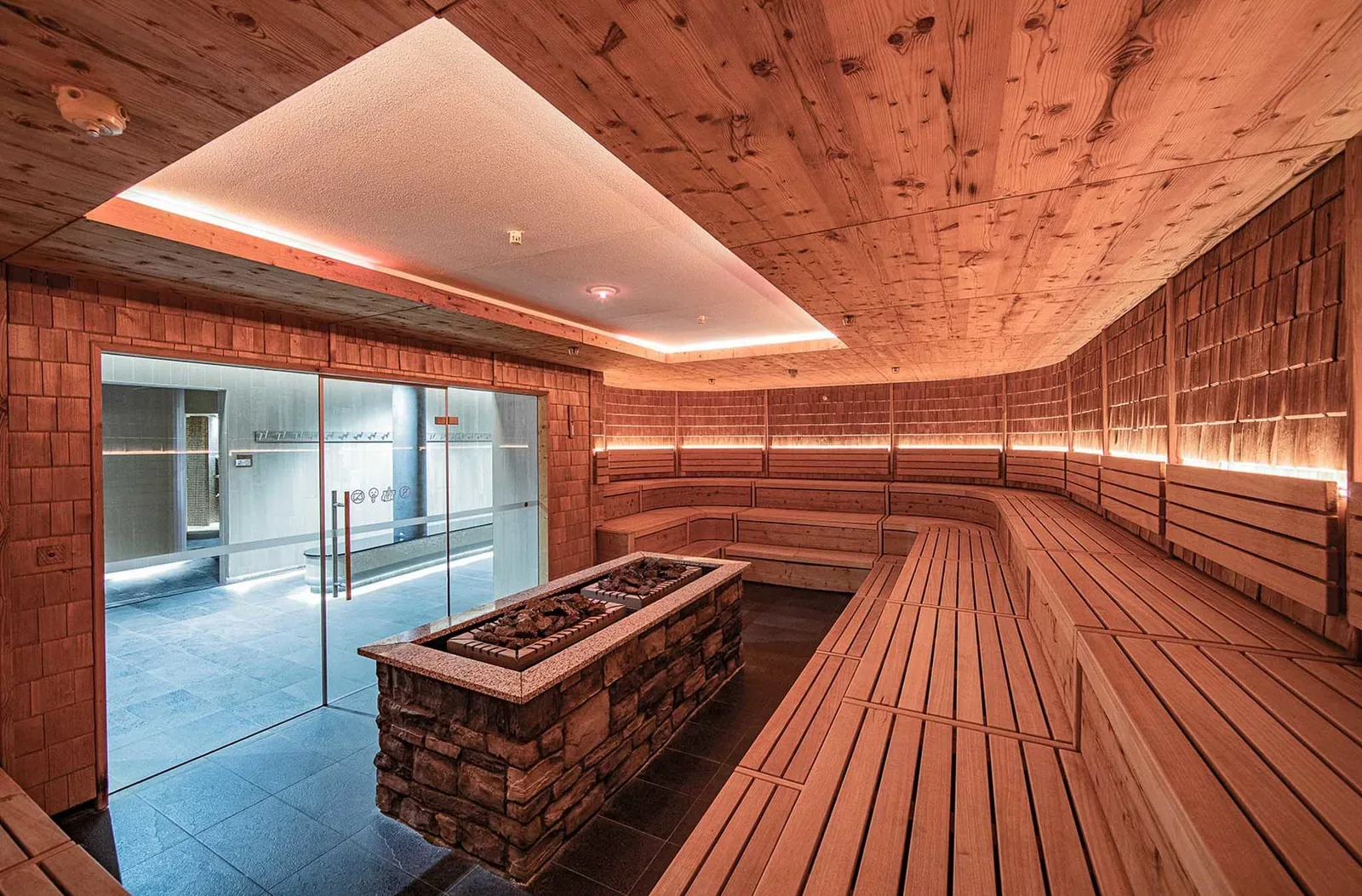 Large wooden sauna with a stone heater in the middle