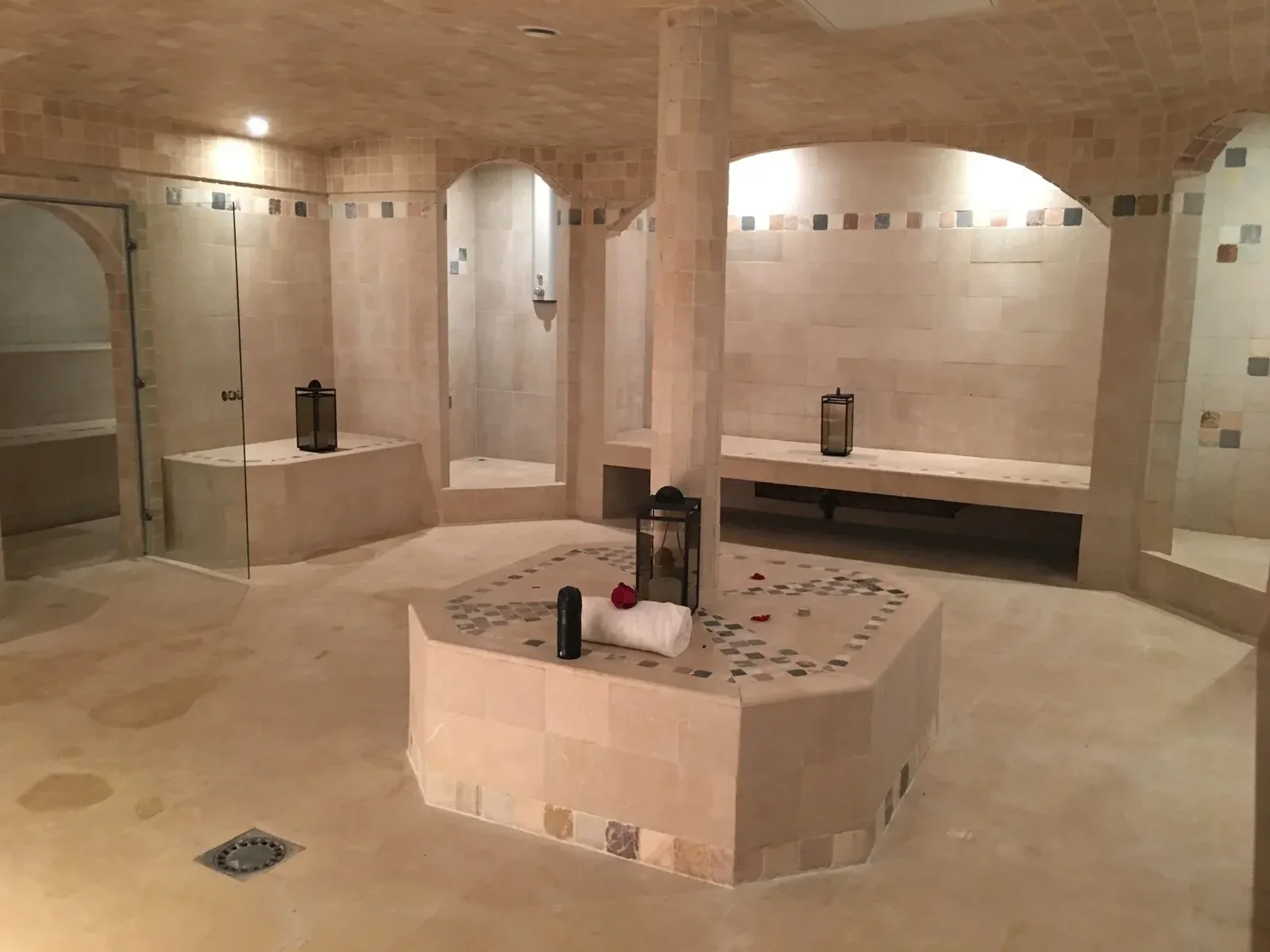 Stone steam room with benches and a central basin