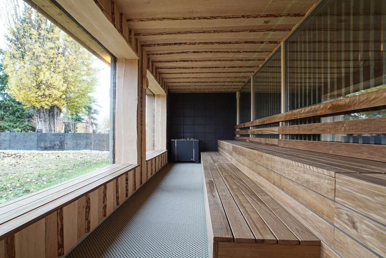Long wooden sauna with tiered benches and a large window