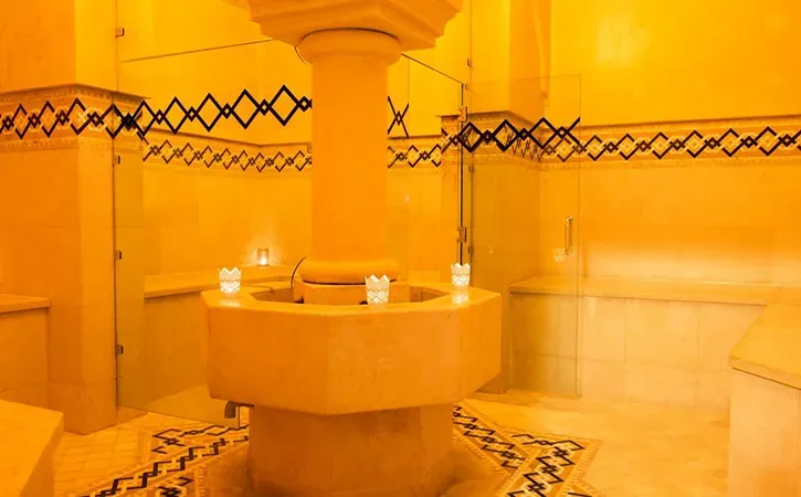 Hammam room with a stone basin and patterned tiles